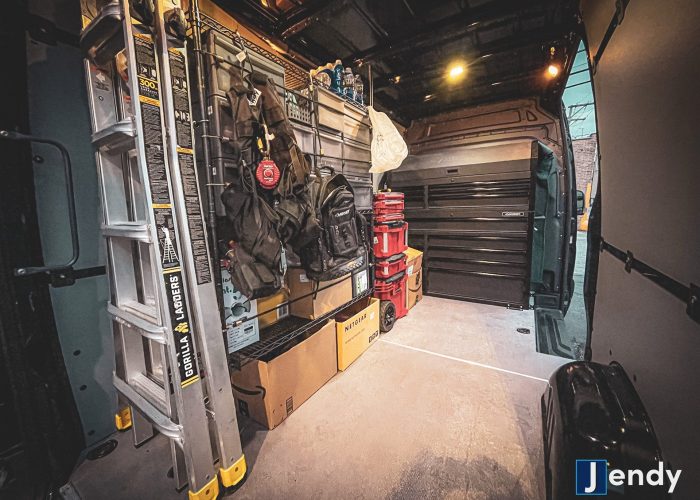 Verkada Installers Interior of a work van neatly organized with ladders, toolboxes, storage bins, bags, and various tools. The flooring is clean, and the Jendy logo is visible in the bottom right corner. Verkada Installers Interior of a work van neatly organized with ladders, toolboxes, storage bins, bags, and various tools. The flooring is clean, and the Jendy logo is visible in the bottom right corner.